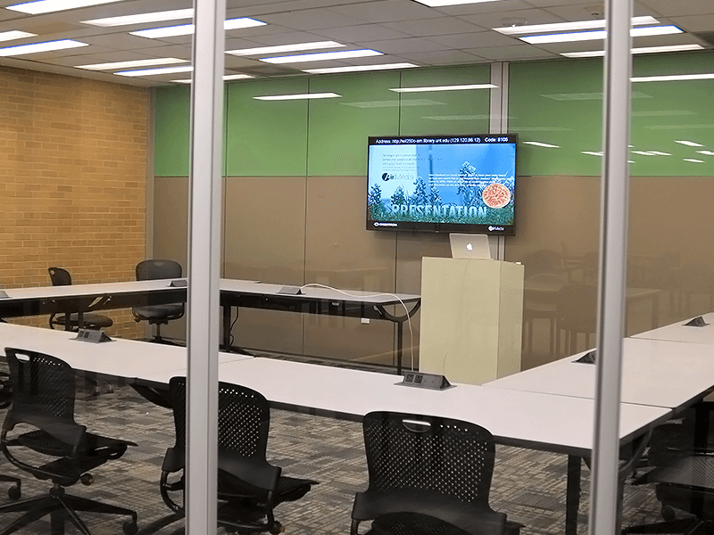study room with tables, chairs, TV screen