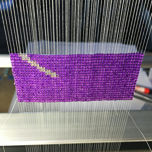 purple beads on a loom