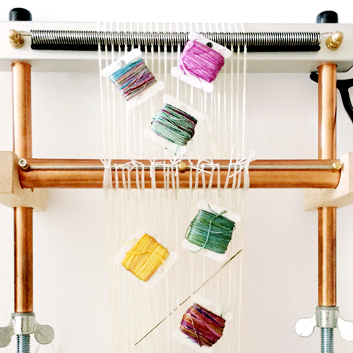 spools of thread on a loom