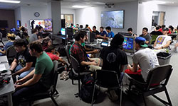 Photo of the Media Library Commons with students playing video games.