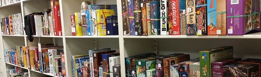 Photo of tabletop games on the library shelf.