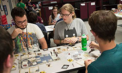 Photo of students playing a tabletop game.