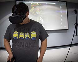 Student in VR headset playing game